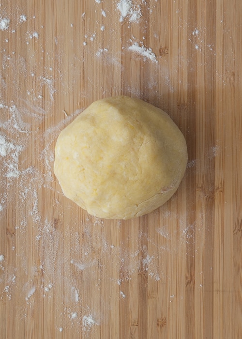 The dough on a wooden board.