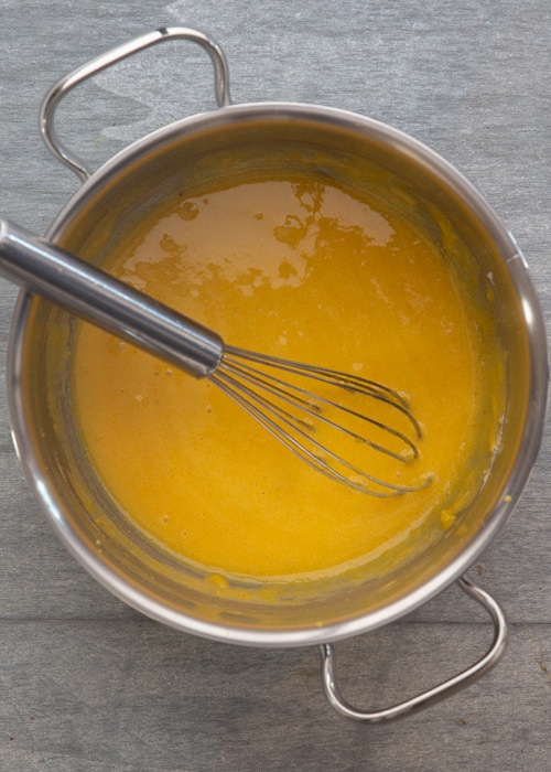 Whisking the yolks, sugar and flour.
