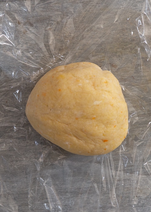 Dough kneaded into a soft dough and wrapping in plastic wrap.