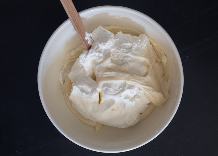 Mixing the cream cheese and whipped cream.