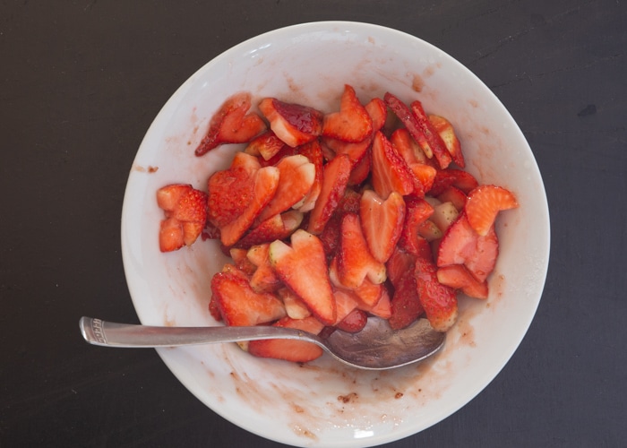 The strawberry mixture mixed in a white bowl.