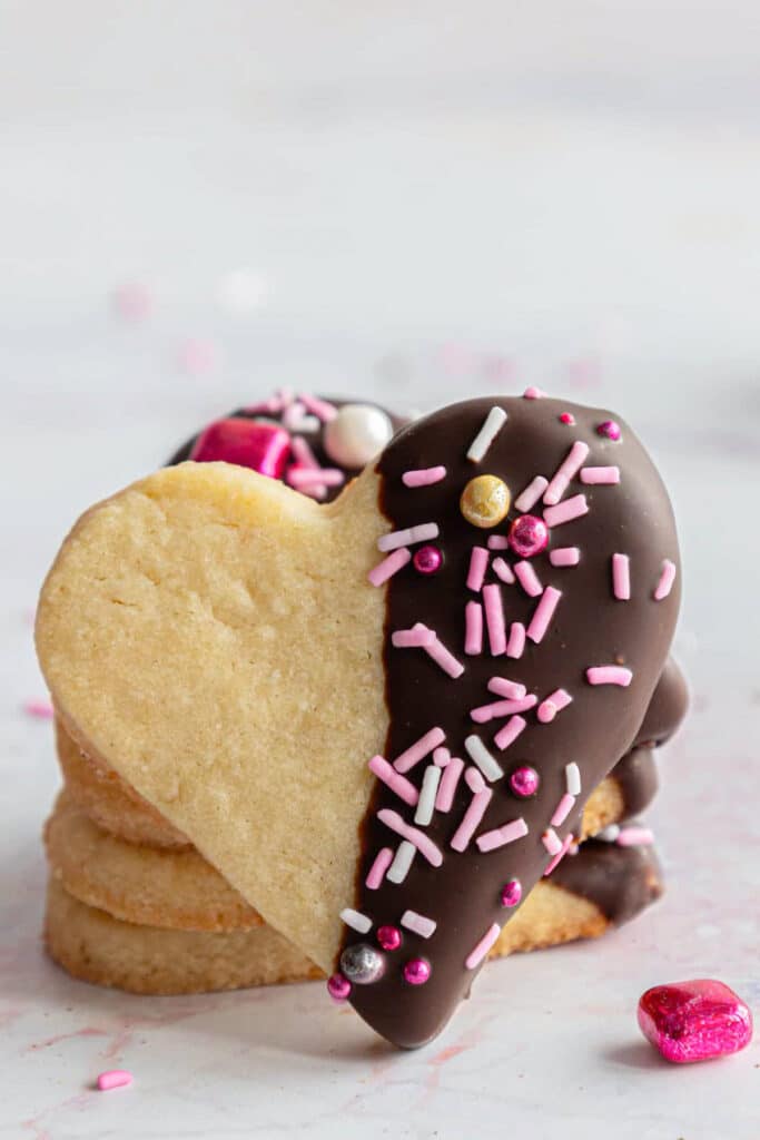 Three cookies stacked with one leaning against them.