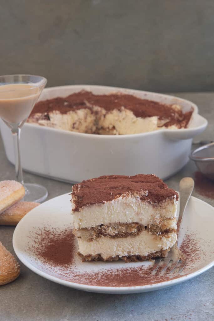 Baileys tiramisu in white pan and on a white plate.