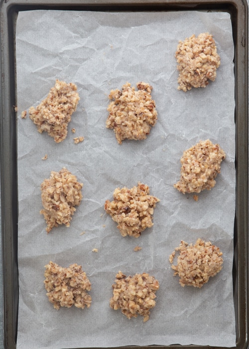 The unbaked cookies on a parchment paper lined baking sheet.