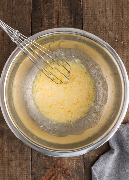 The wet ingredients whisked in a silver bowl.