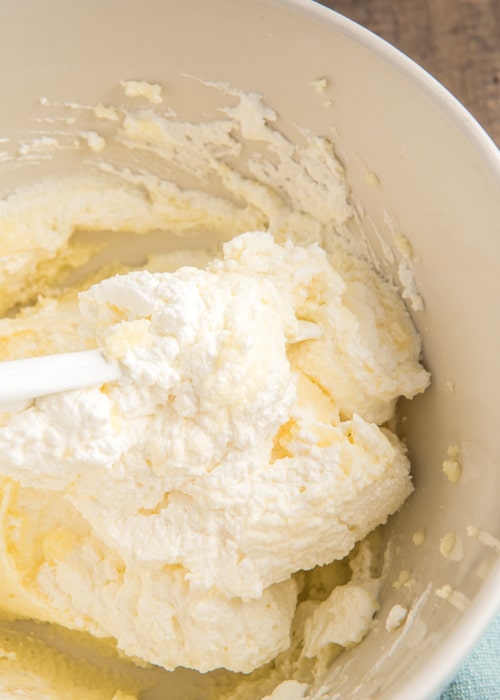 Mascarpone and whipped cream mixed in a white bowl.