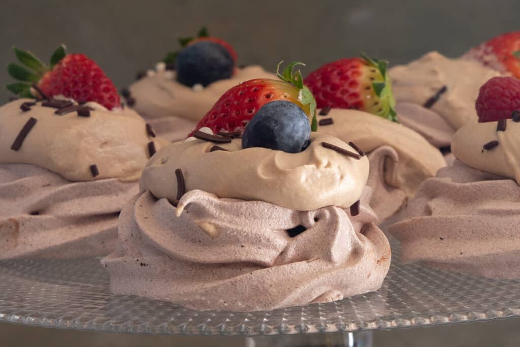 Meringue clouds on a white cake stand.