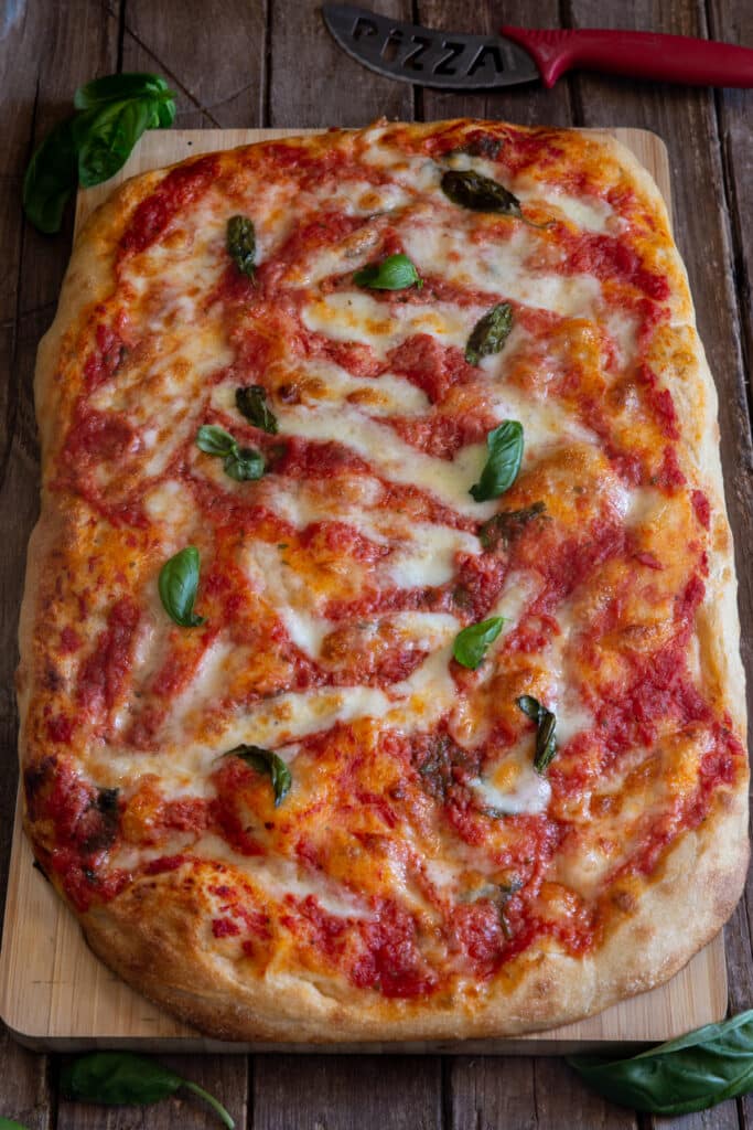 Pizza Margherita on a wooden board.