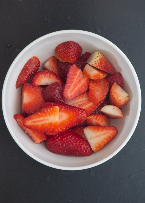 Strawberries sliced in a bowl.