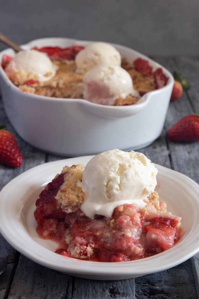 The crumble in the pan and some on a plate with ice cream.