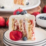 A slice of vertical cake on a white plate.