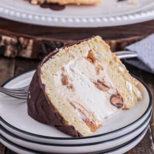 A slice of cake on a white plate.