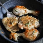 Pan fried chicken in a black skillet