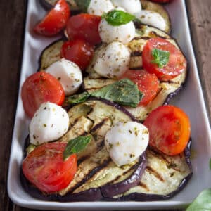 Caprese eggplant on a white dish.