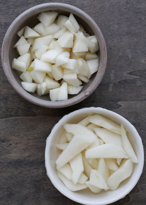 The pears cubed and sliced in two bowls.