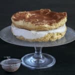 Choux cake on a glass cake stand.
