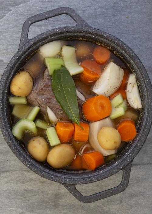 Roast and vegetables and broth mixture in the pot.