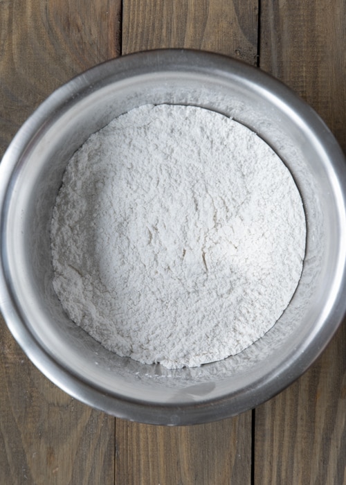 The flour sifted in a silver bowl.