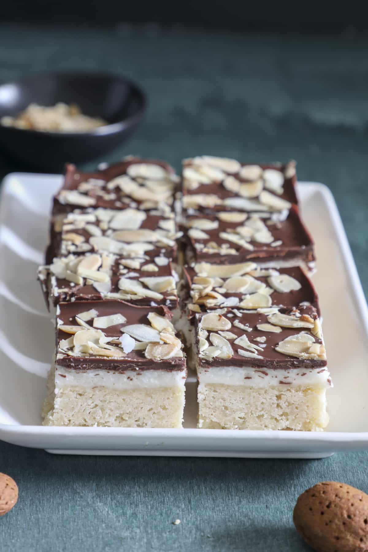 Chocolate almond bars on a white plate.