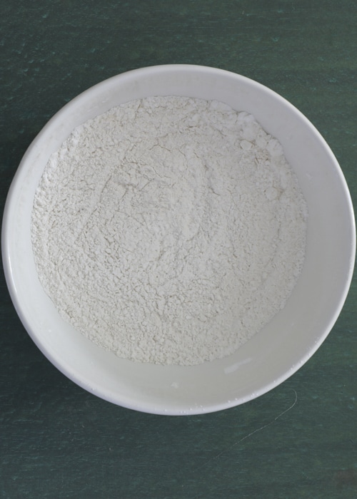 The dry ingredients sifted in a white bowl.