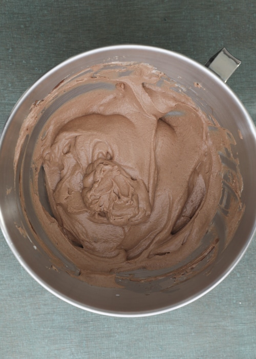 Adding the chocolate to the whipped cream.