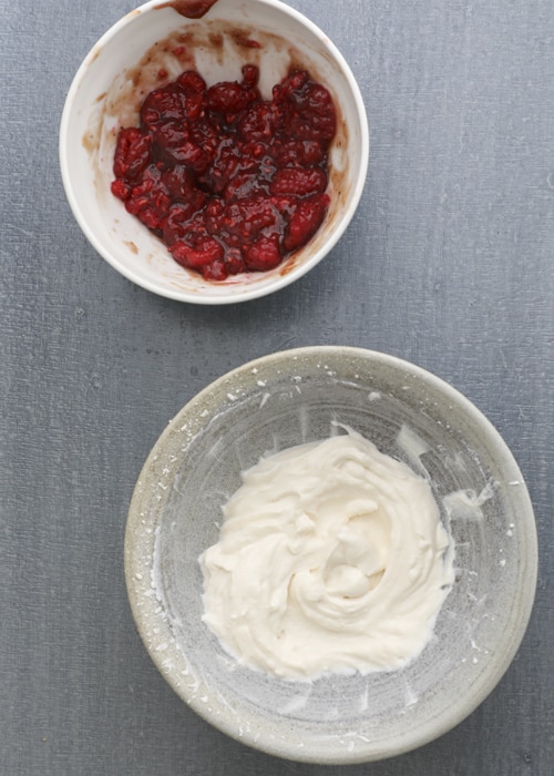 Mixing the ricotta filling and raspberry filling in bowls.