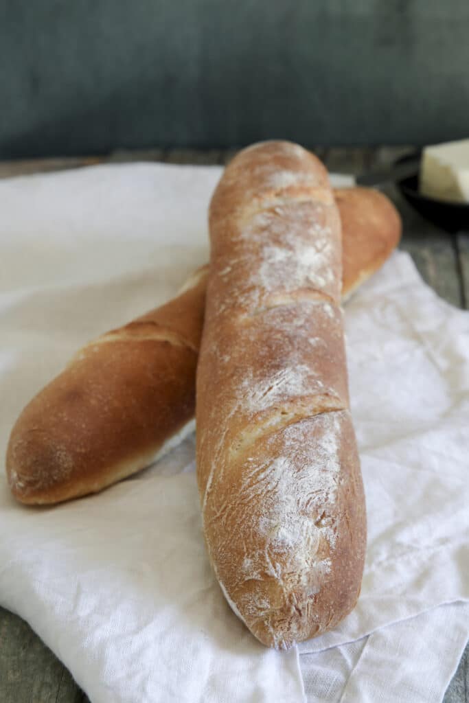 Two baguette on a white napkin.