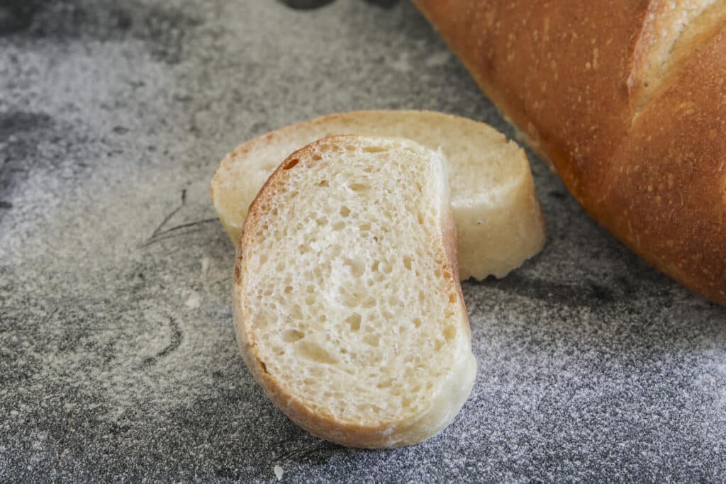 Two slices of bread on a flour dusted board.