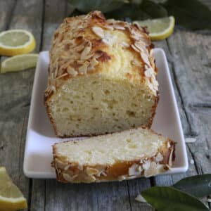 Lemon ricotta bread on a white tray with a slice of bread.