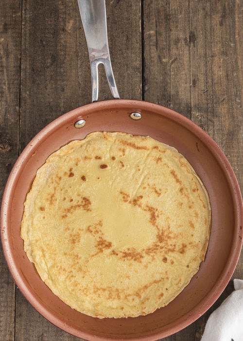 The cooked crepe in the pan.