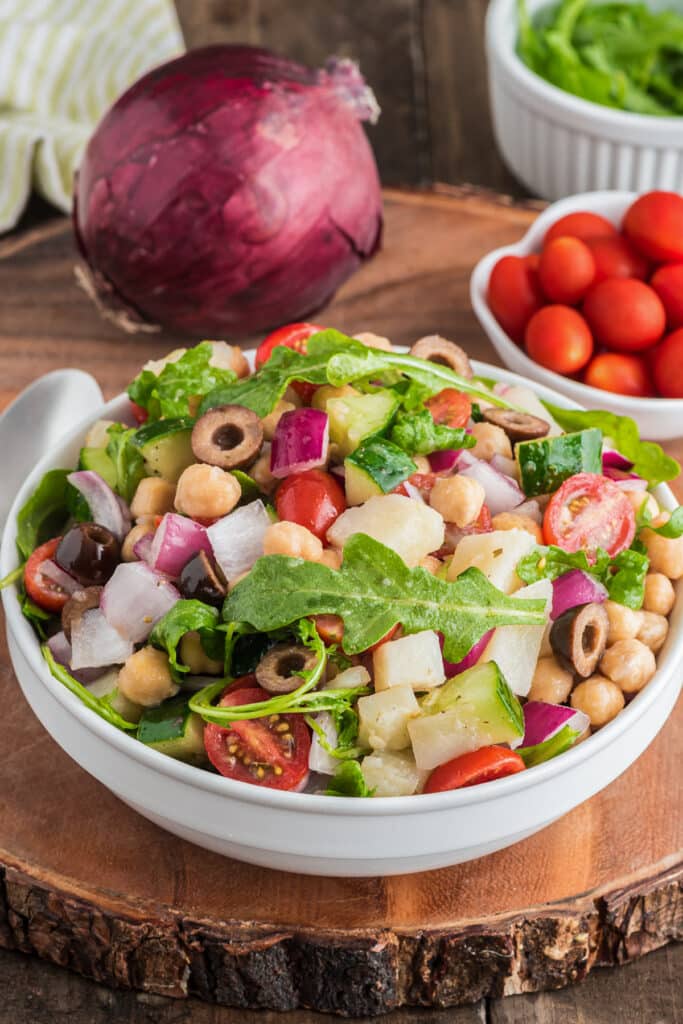 Chickpea salad in a white bowl.