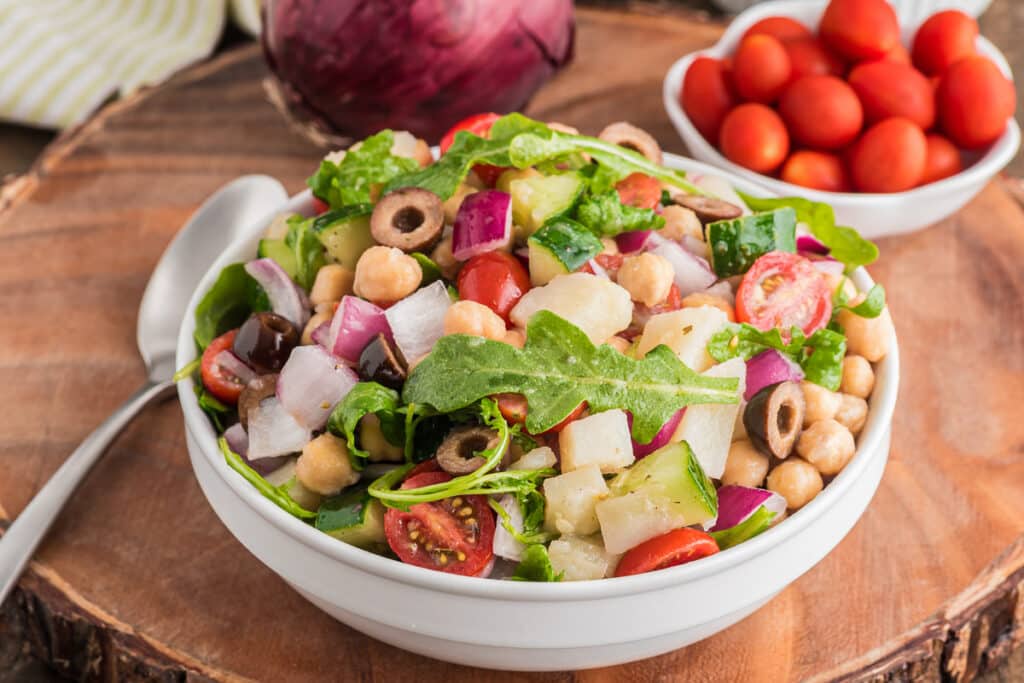 Chickpea salad in a white bowl.