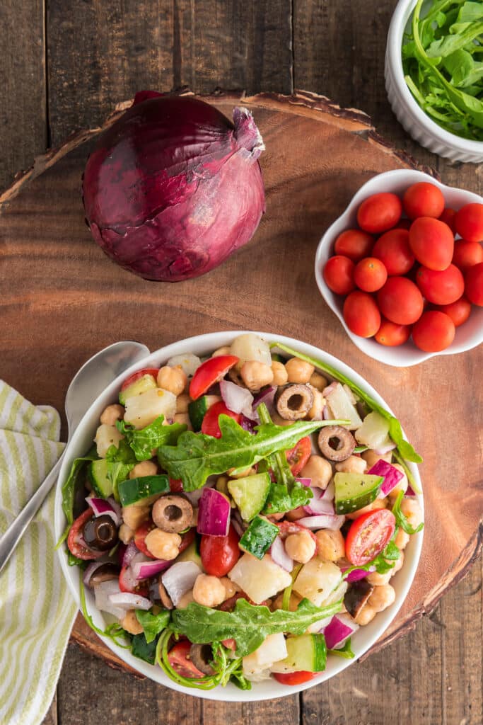 Chickpea salad in a white bowl.