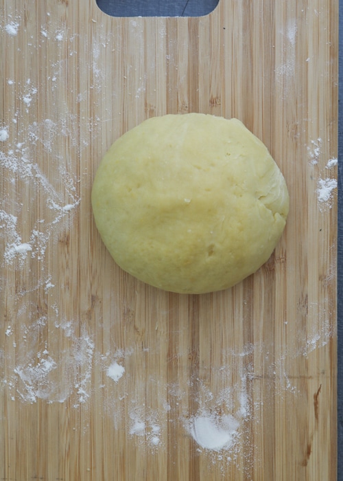 The dough formed on a wooden board.