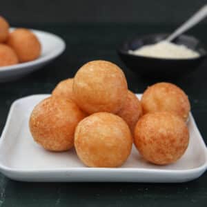 Cheese balls on a white square plate and a round plate.