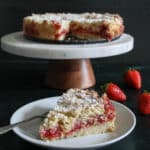 Cake on a cake stand and a slice on a cake