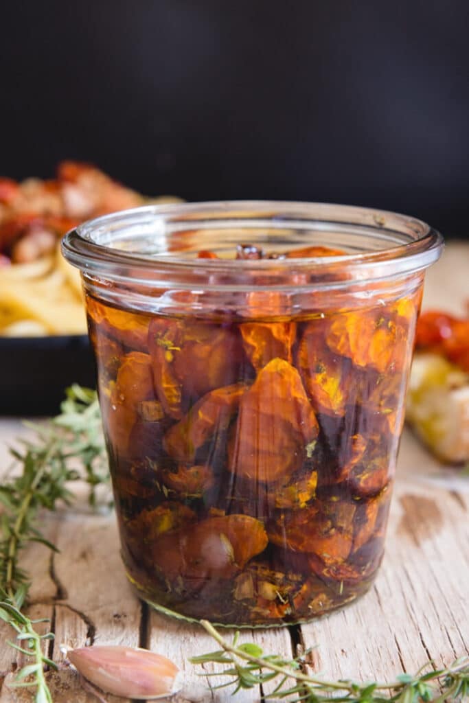 Candied tomatoes in a glass jar.