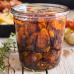 Candied tomatoes in a glass jar.