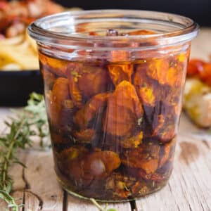 Candied tomatoes in a glass jar.