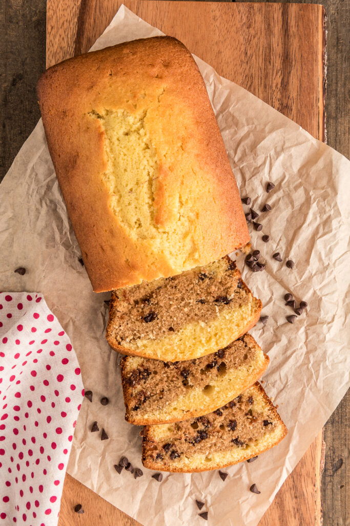 Chocolate chip pound cake with three slices cut.
