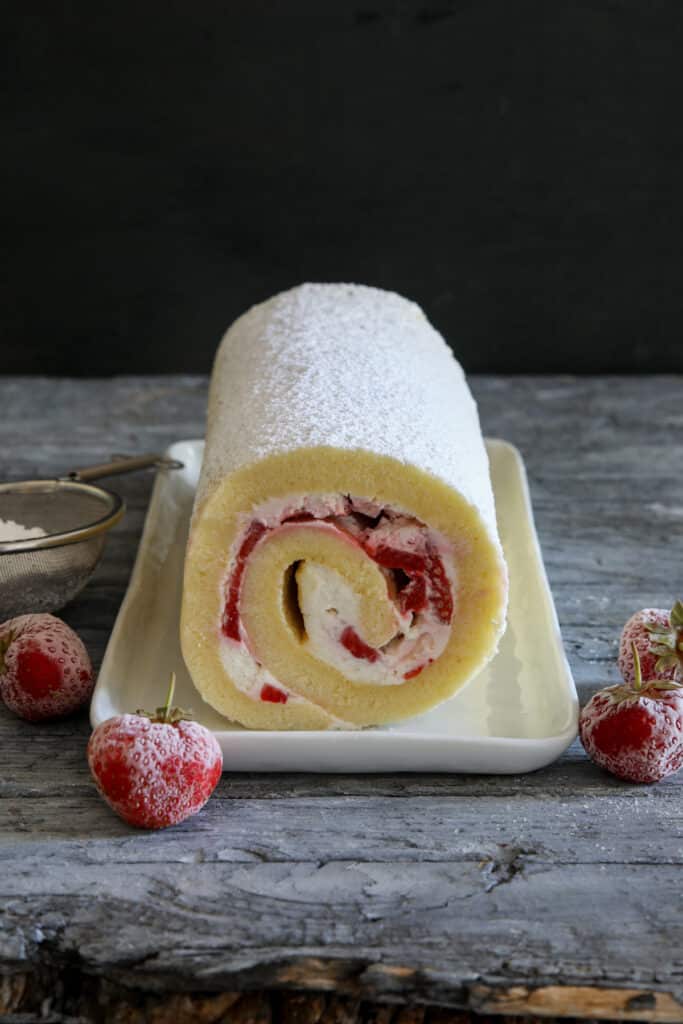 Cake roll on a white plate.