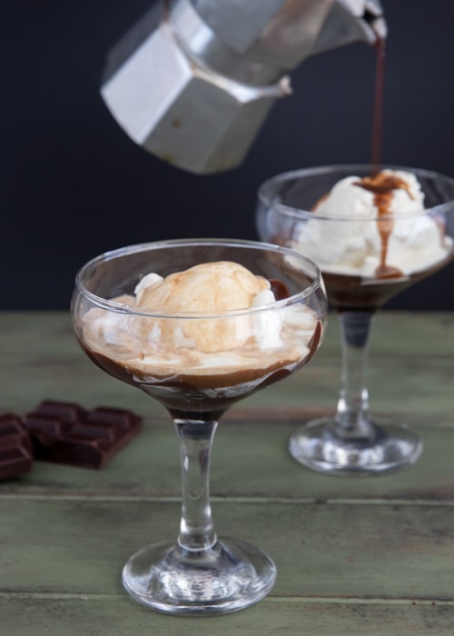 Pouring chocolate over the ice cream.