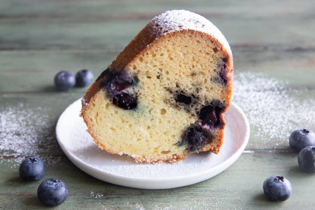 A slice of cake on a white plate.