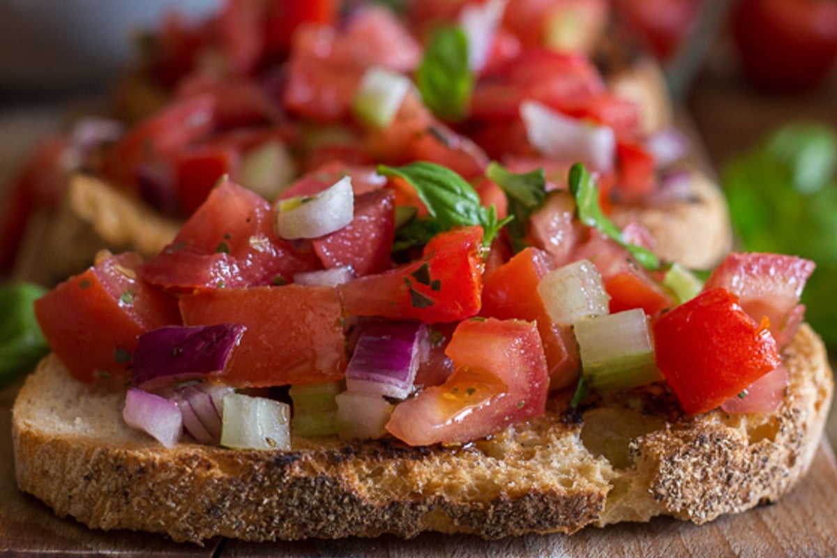 Tomato bruschetta on a piece of bread.