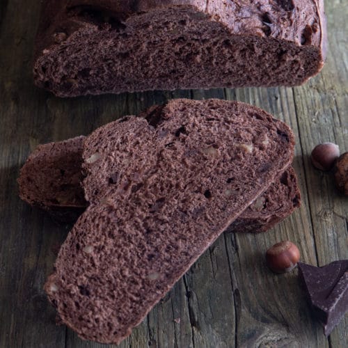 Chocolate yeast bread with two slices cut.