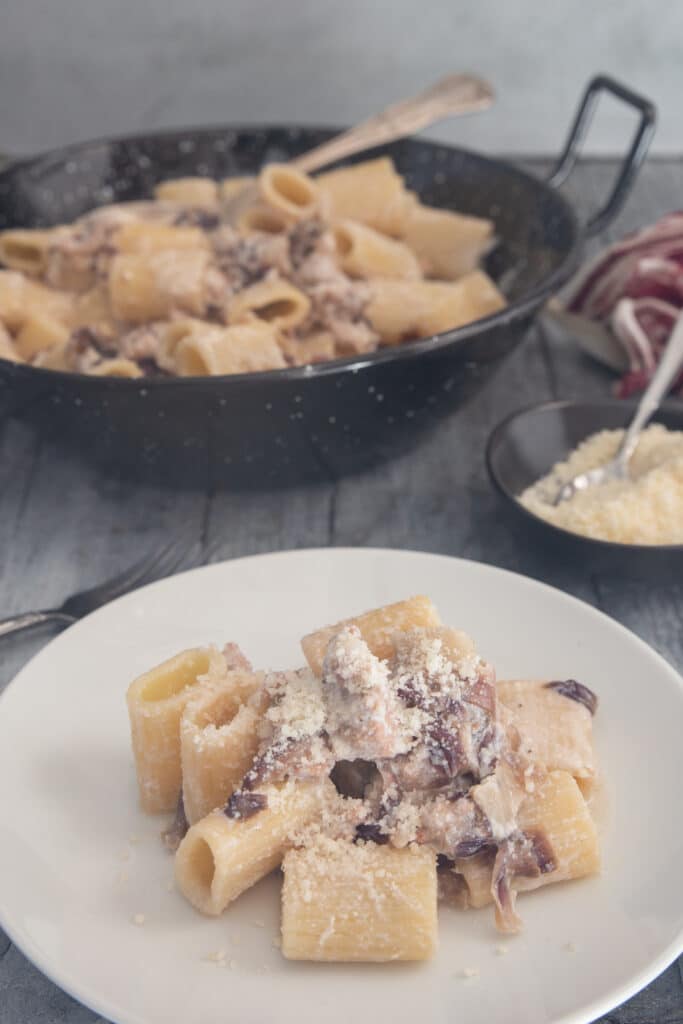 Pasta in the pan and some on a plate.