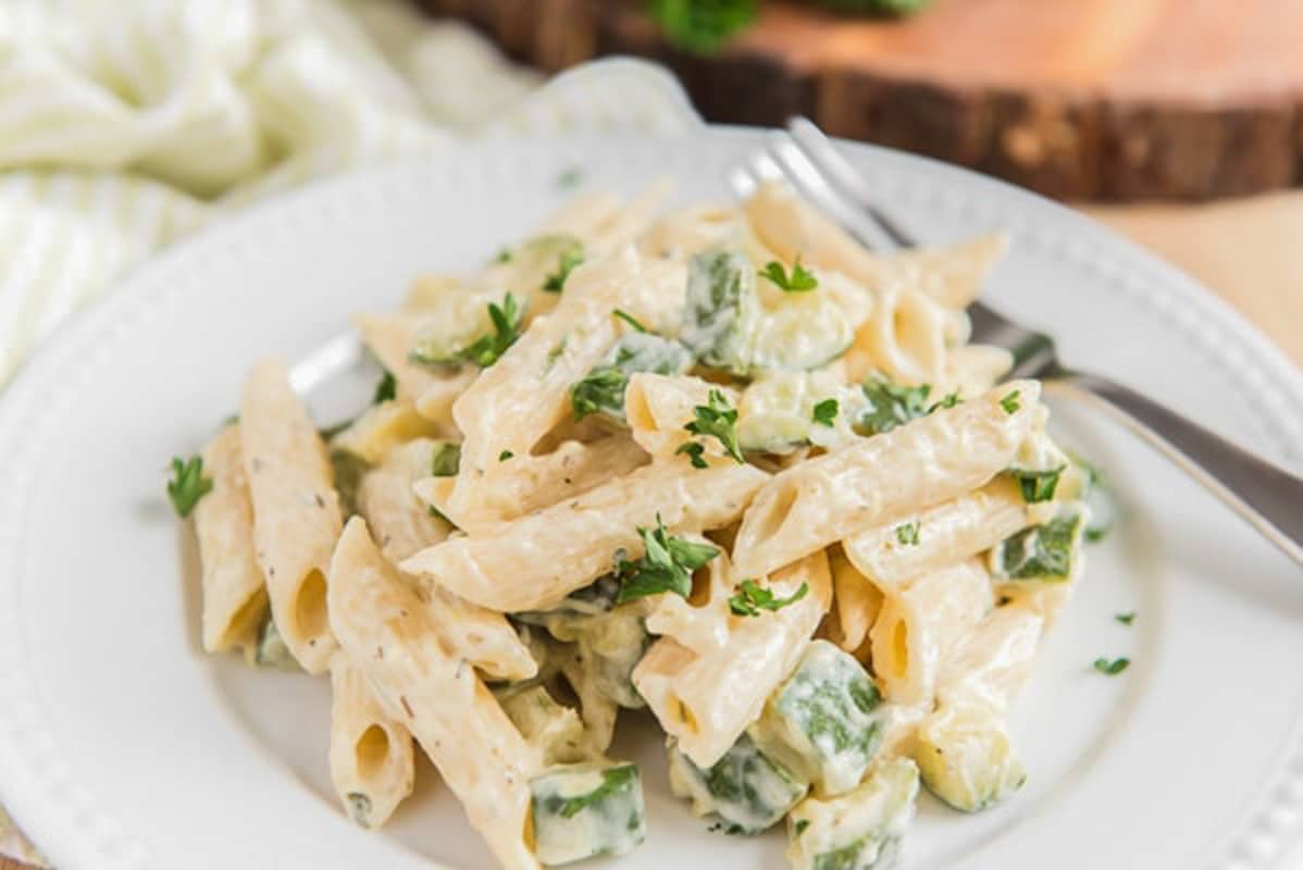 Cream cheese pasta on a white plate.