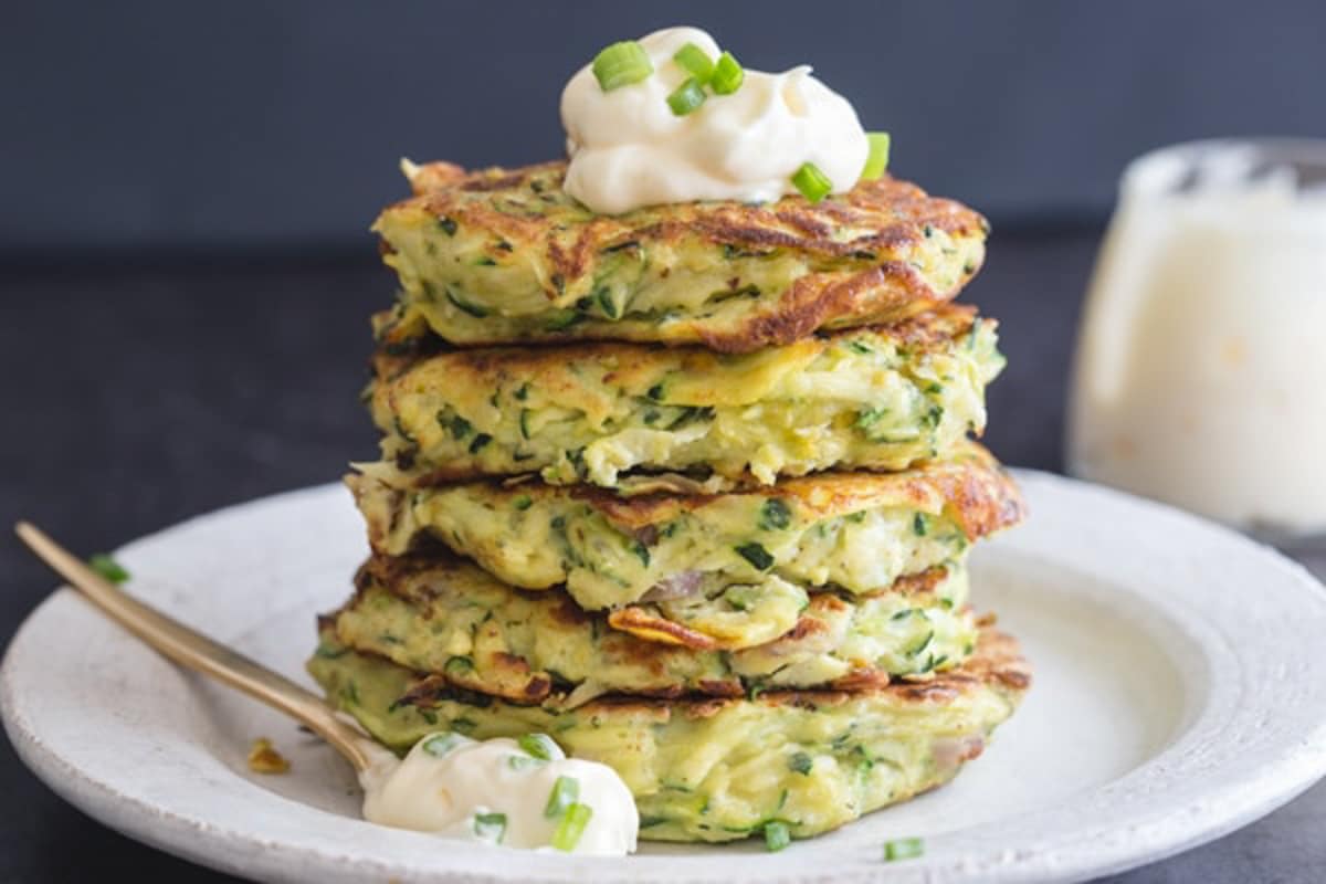 Four zucchini patties stacked.