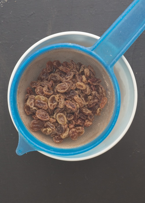 The raisins drained in a sifter.