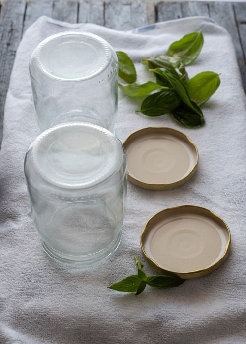 The washed jars upside down on a clean tea towel.